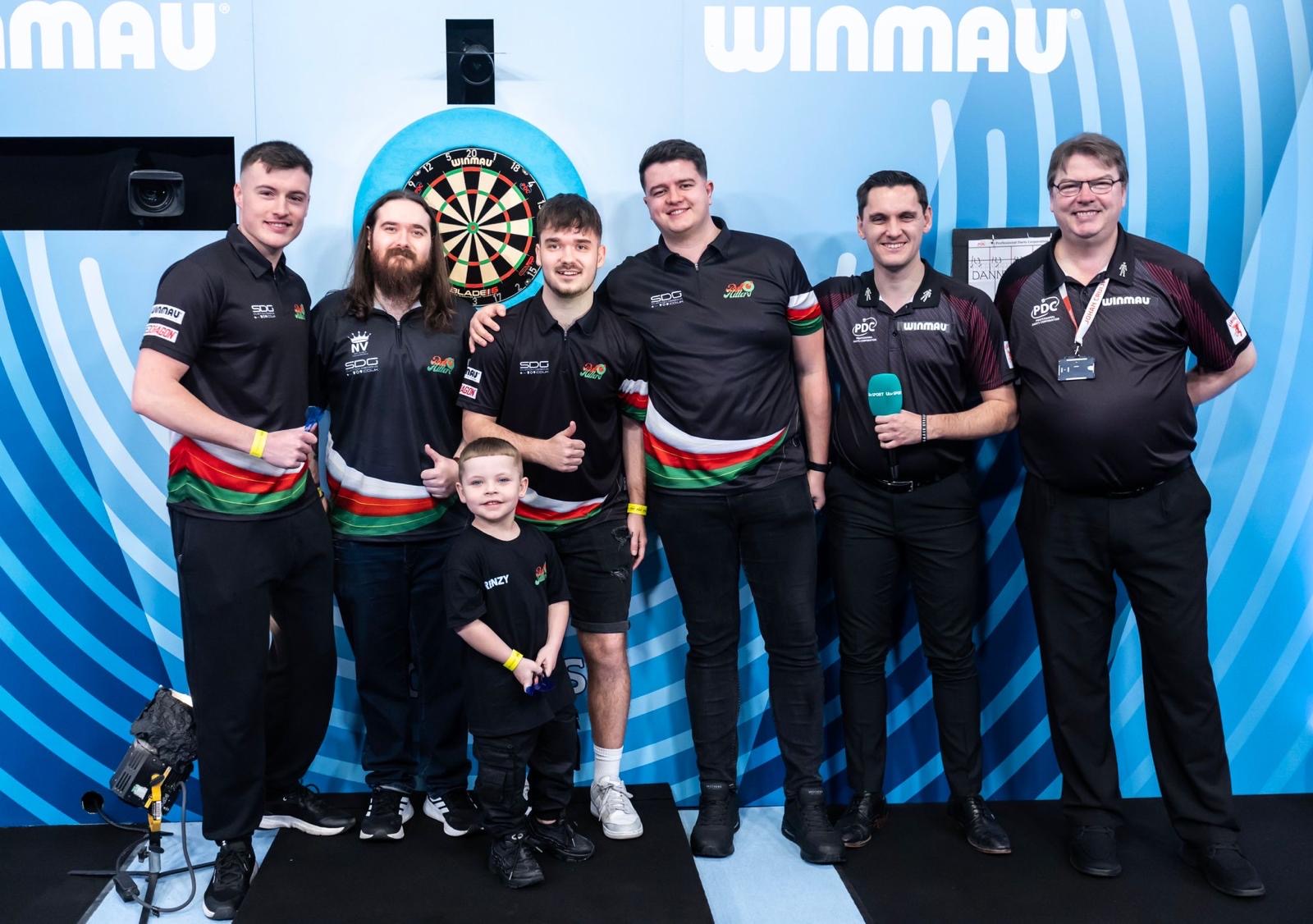 The BullHitters collective on the PDC stage with a young fan
