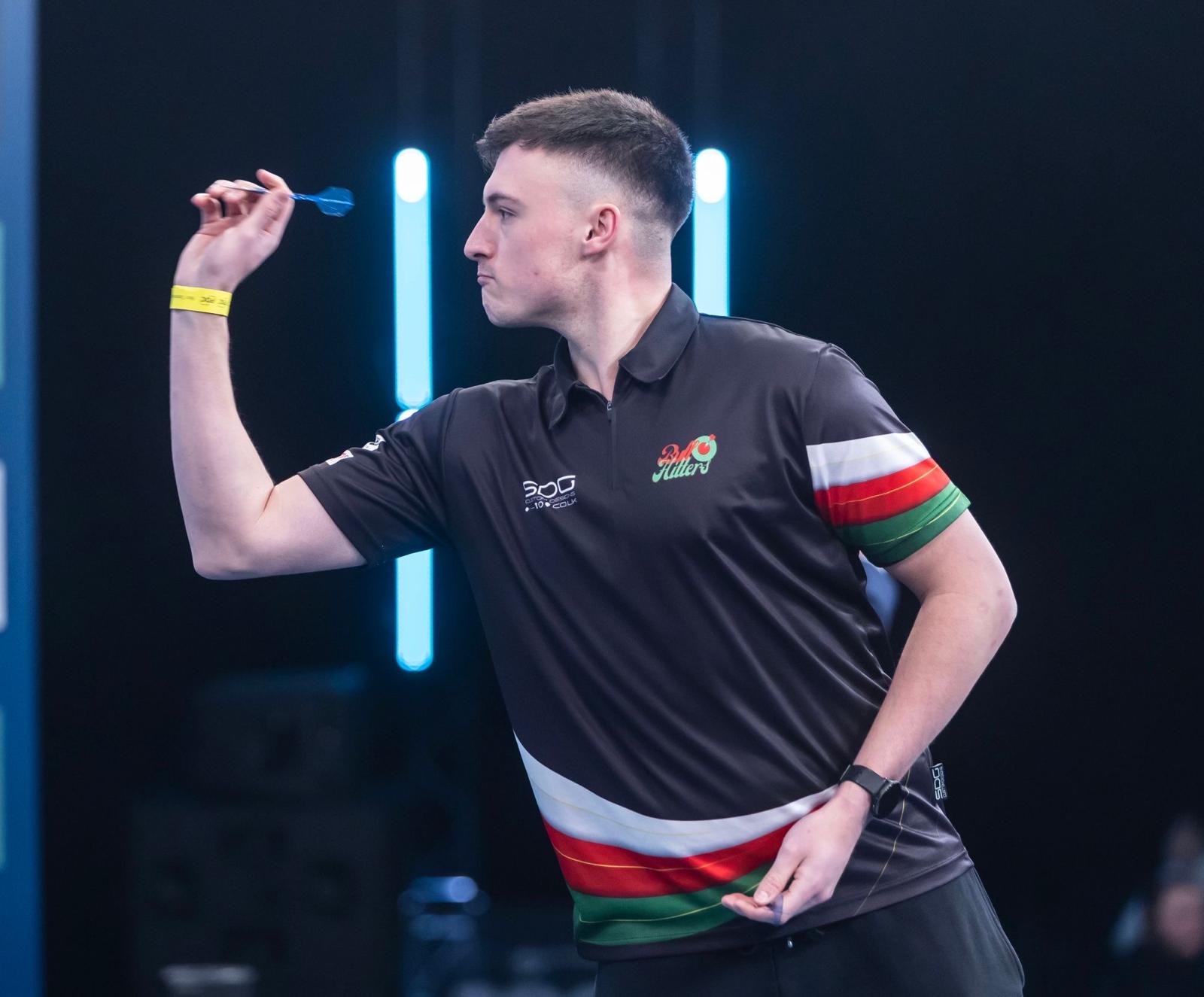 BullHitters creator throwing a dart on stage